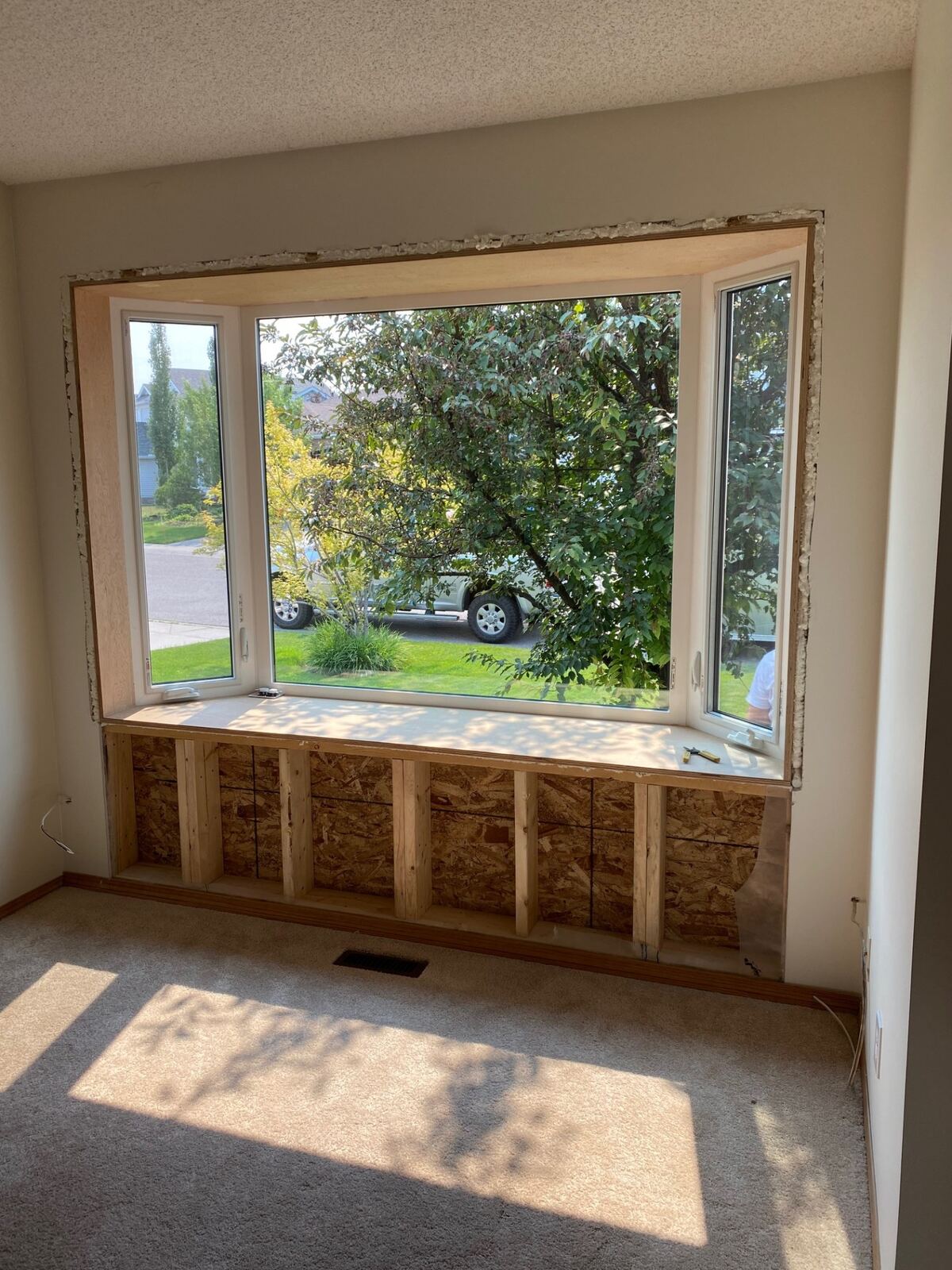 Bay window with custom bench seat installed in living room